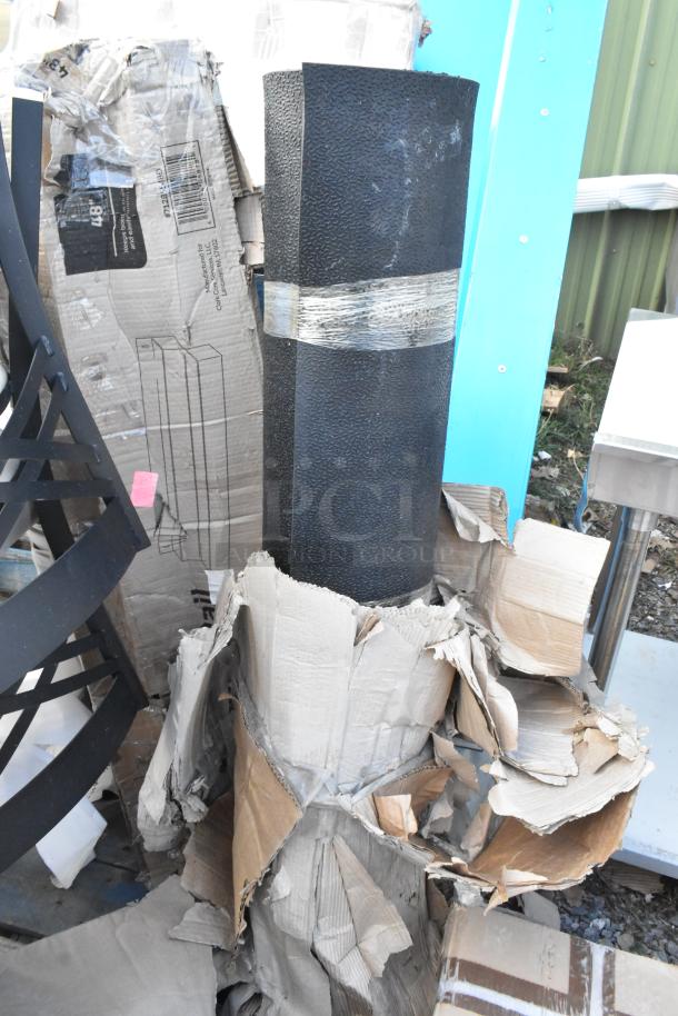 Black heavy-duty multipurpose mesh tarp with textured surface, packaged in partially damaged cardboard. New condition.