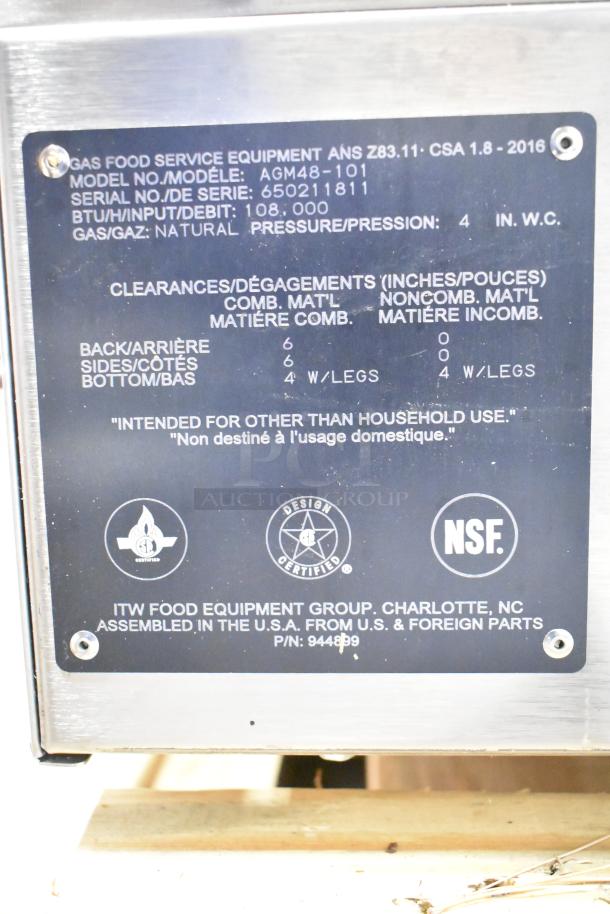 Wolf AGM48-101 stainless steel countertop natural gas griddle, 108,000 BTU. Label shows model, serial number, ANSI, and CSA standards compliance.