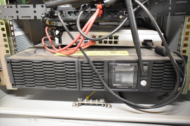 BlackShields DC0300 white metal cabinet with Cradlepoint and CyberPower PR1000LCDRT2U UPS, electronics visible in rack.