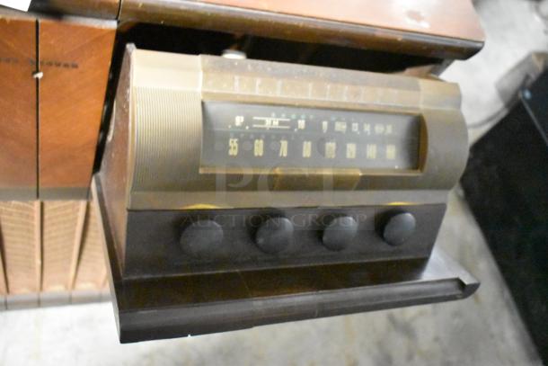 Victrola RCA Victor 67V1 wood pattern counter with record player, featuring a vintage design and control knobs.