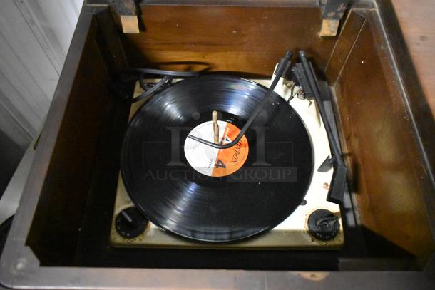 Victrola RCA Victor 67V1 record player with wood pattern counter, visible record on turntable. Classic vintage condition.