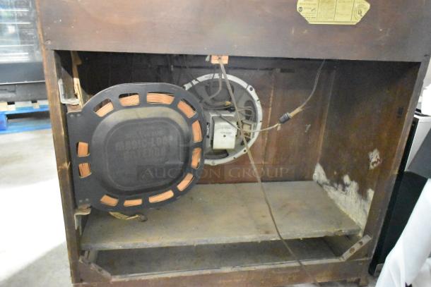 Victrola RCA Victor 67V1 wood-pattern counter with record player, showing interior wiring, speaker, and UL label.