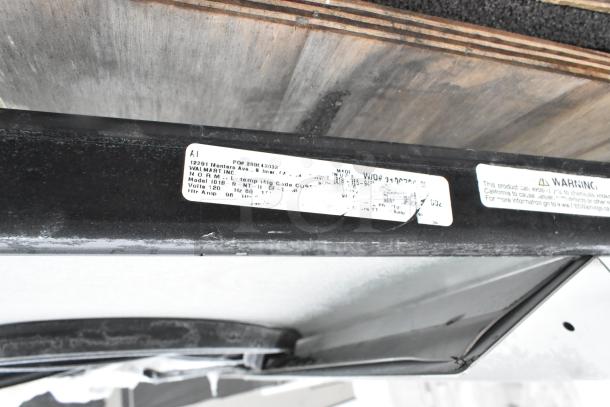 Brand new Anthony 101B-R-NT-H-CF-L doors, size 29-1/16"x66-9/16". Visible label shows model and voltage details.