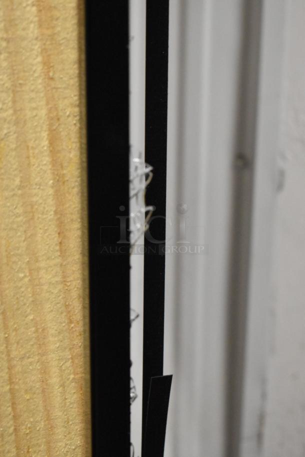 Brand new Hussmann MDN-4775B1A 47" black vertical open-air merchandiser, showing minor scratches on the side.