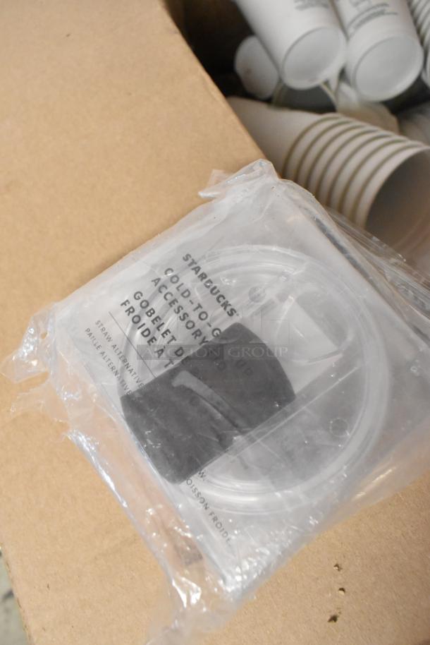 Lot of various items including paper Starbucks cups, packaged cold-to-go cup accessory, and tongs in mixed condition.