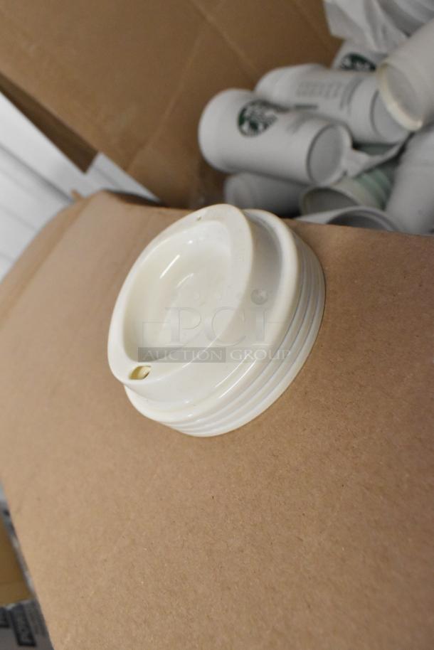 Lot of various items includes paper Starbucks cups and white lids. Items appear unused, ideal for resale or personal use.