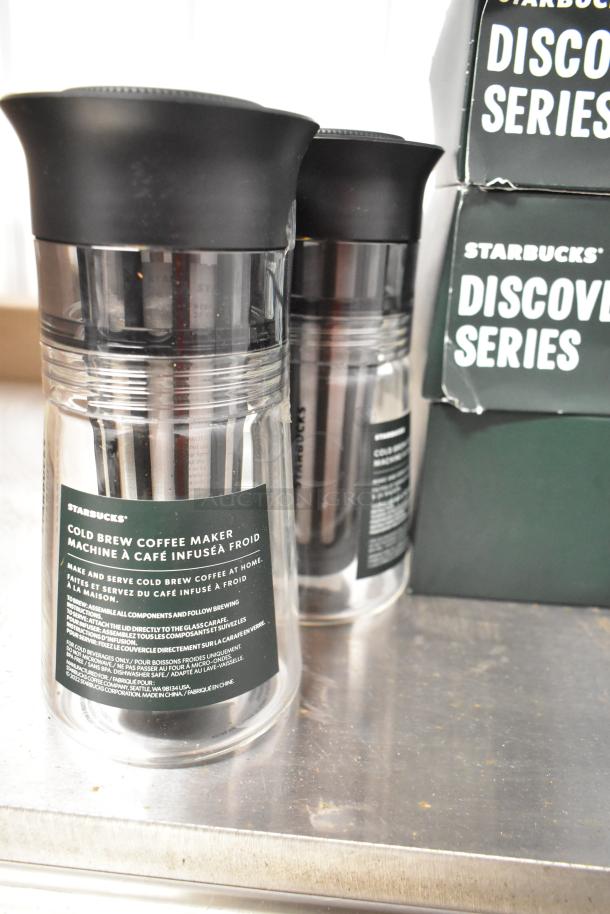 Starbucks Cold Brew Coffee Makers and Discovery Series Mugs, new condition, labeled for home use, part of auction lot.