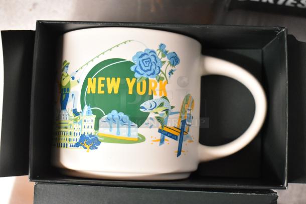 New York Discovery Series mug with vibrant city-themed illustrations in a black box.