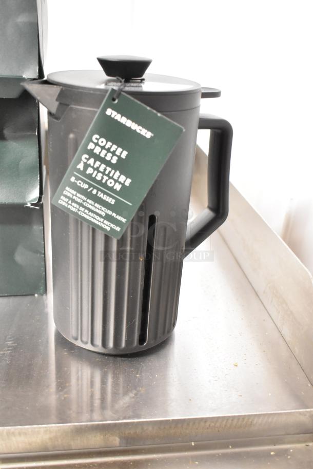 Black Starbucks coffee press, 8-cup capacity, with tag indicating sustainable construction from recycled materials.