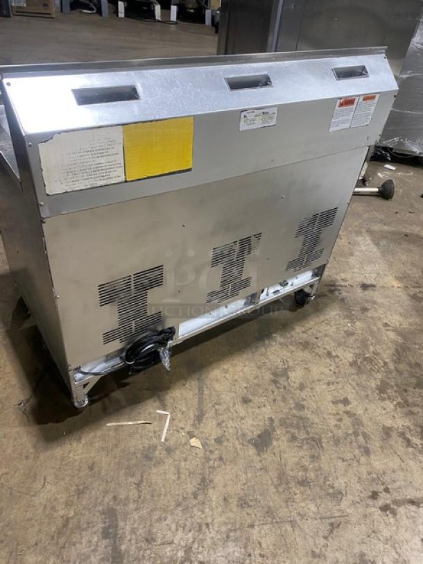 Henny Penny Evolution Elite Series commercial stainless steel deep fat fryer, model EEG-253, natural gas, triple bay, with back splash and basket hanger, on casters.