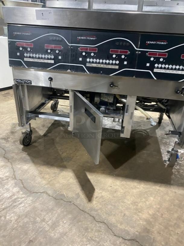 Henny Penny Evolution Elite triple bay deep fat fryer system, model EEG253. Stainless steel, casters, backsplash, basket hanger.
