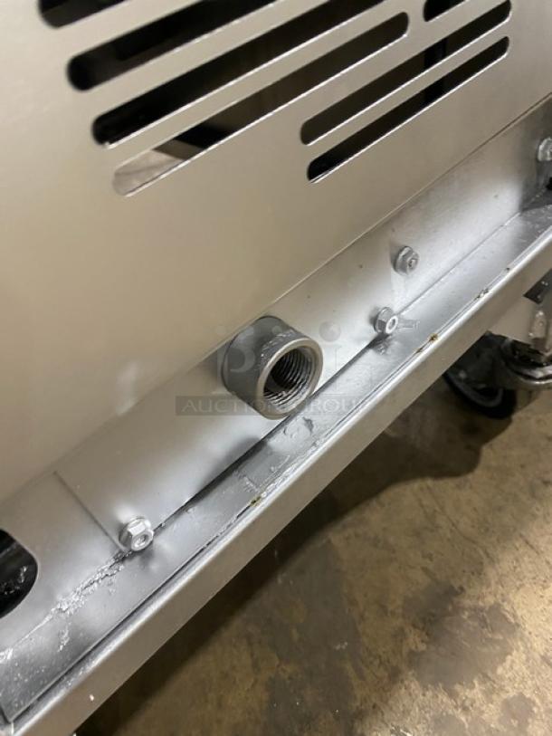 Henny Penny Evolution Elite Model EEG-253 stainless steel fryer detail, showing gas connection and part of the caster in used condition.