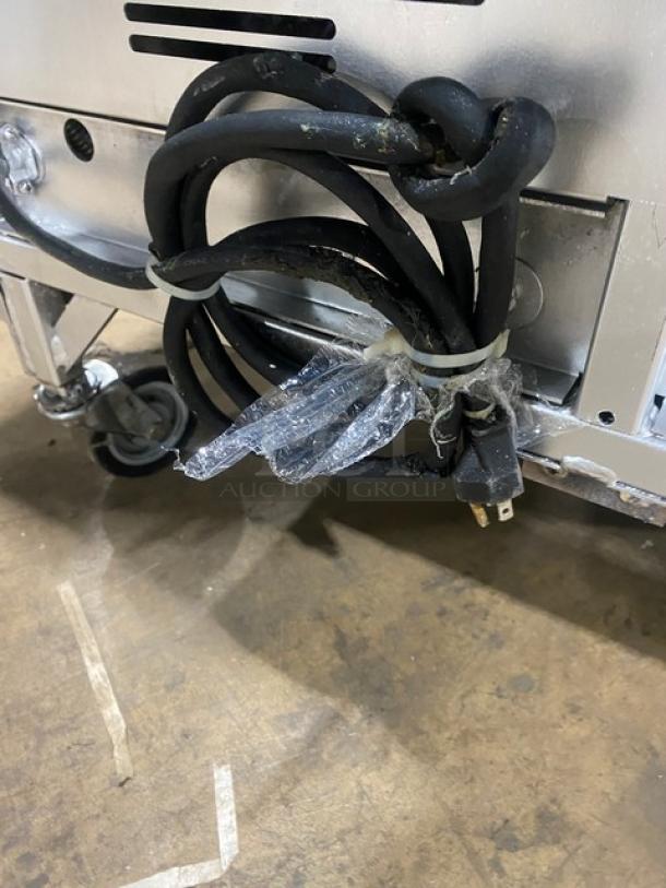 Henny Penny EEG-253 commercial deep fryer, stainless steel, natural gas, triple bay, on casters, back splash, basket hanger.