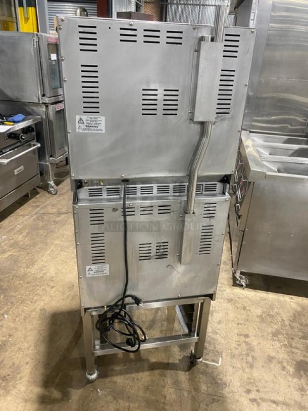 Moffat Turbofan Series E23M3 double-stacked stainless steel convection oven on casters, includes wired rack and pan stand.