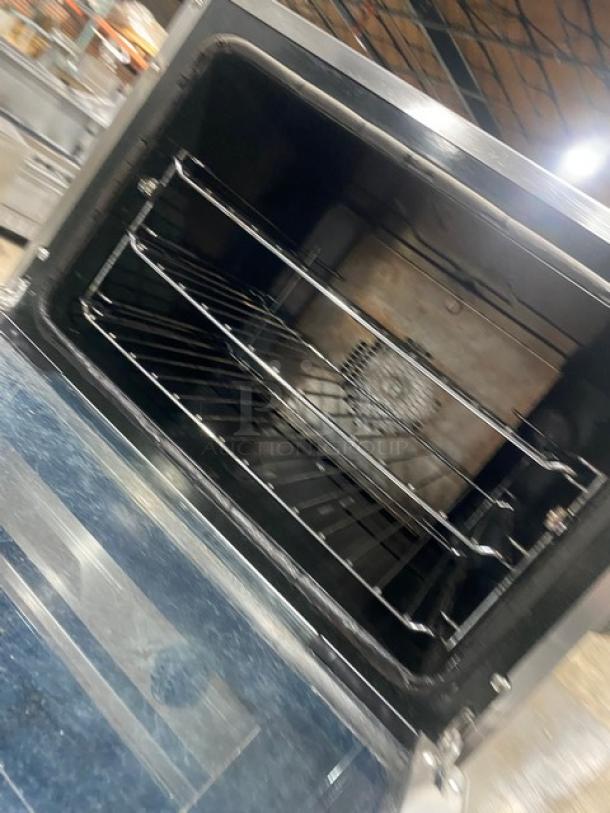 Moffat Turbofan E23M3 convection oven interior showing wired oven rack, stainless steel finish, on casters, 220-240V.