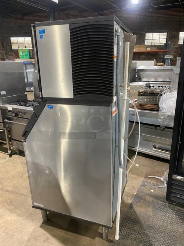 Manitowoc Indigo Series stainless steel ice machine, electric-powered, leg-mounted, vented top, visible power and water connections.