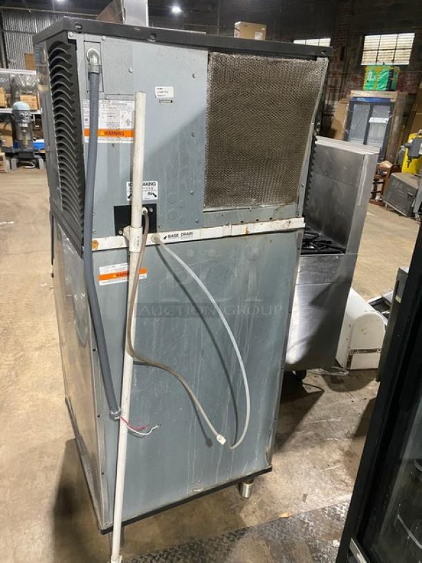 Manitowoc Indigo Series commercial stainless steel ice maker/bin combo on legs, electric powered; shows labels and electrical wiring.
