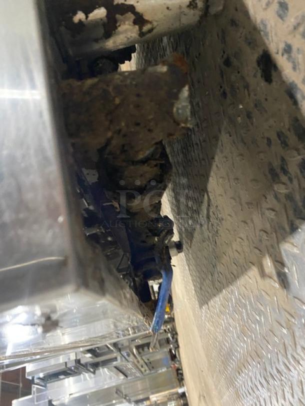 Commercial stainless steel gas-powered seafood steamer with individual controls, wired oven rack, and mounted on legs.