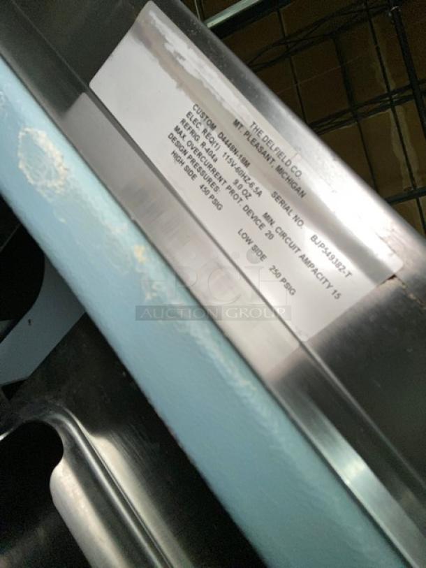Delfield D4448N-18M stainless steel 4-drawer refrigerated prep table with visible label. Serial No: BJP549382-T, 115V.