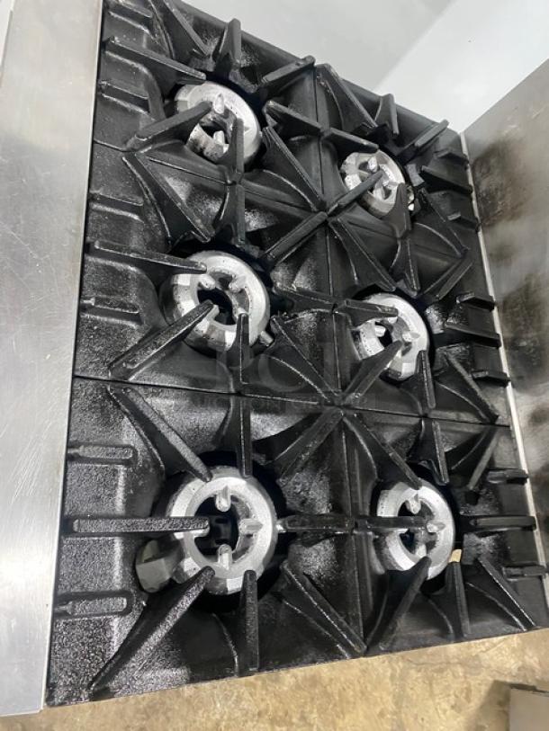 SunFire commercial stainless steel 6-burner range/oven combo, natural gas, with backsplash, salamander shelf, and casters.