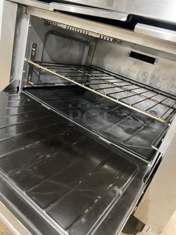 SunFire stainless steel 6-burner range/oven combo, natural gas powered, with backsplash, salamander shelf, and wired oven rack.