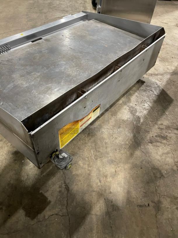 Wolf commercial stainless steel gas countertop flat griddle with back and side splash, on legs, used condition.