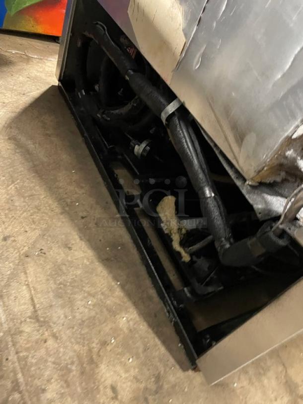 True T-35F commercial stainless steel 2-door reach-in freezer underside view. Features poly-coated wired rack, model tag visible.