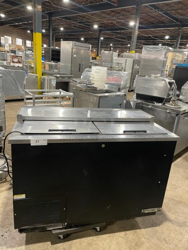 Beverage-Air DW49 black 50" bottle cooler, stainless steel top, double slide lids, SN: 8007027, in warehouse setting.