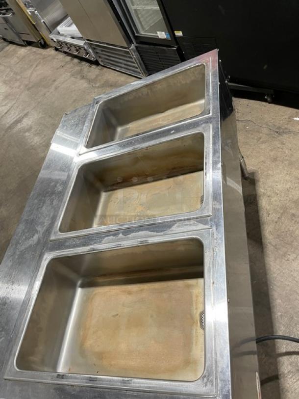 Eagle Group stainless steel 3-well hot food/steam table with tray slide, single undershelf, on legs. Commercial use.