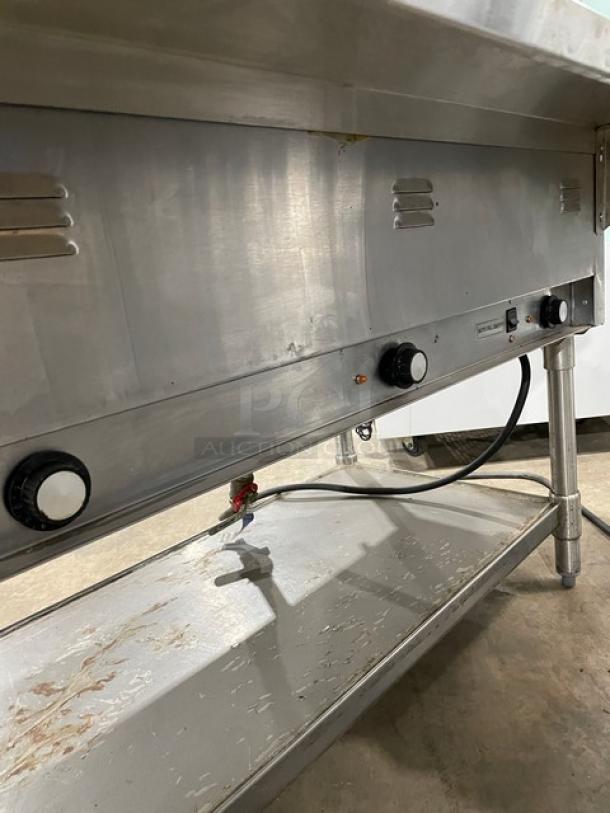 Eagle Group stainless steel 3-well hot food/steam table with tray slide, single undershelf, and legs. Electric powered.