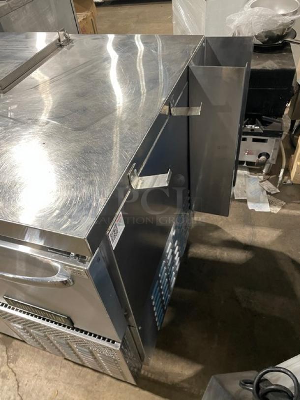 Continental RA68NB refrigerated prep table with 2-1/2 doors, poly-coated wired rack, stainless steel, on casters.