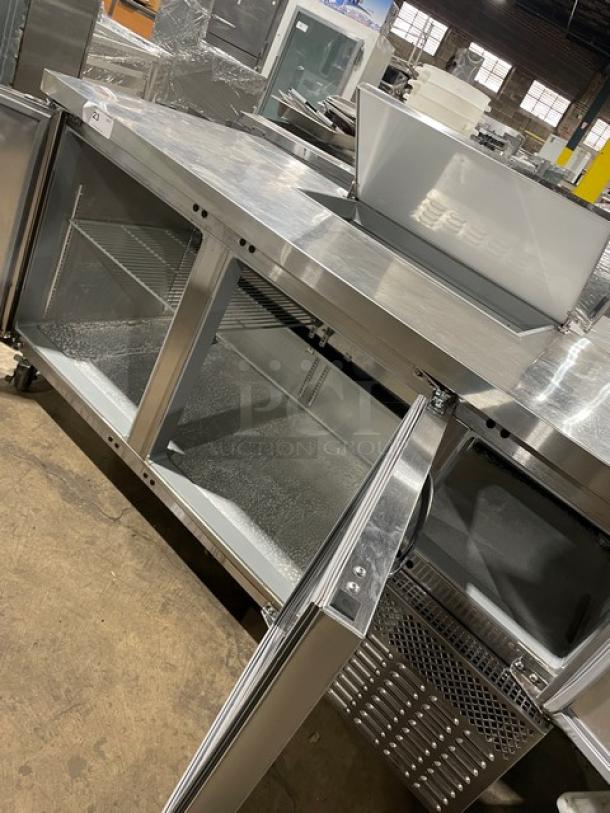 Continental RA68NB stainless steel 2-1/2 door refrigerated prep table with poly-coated wire rack, on casters, excellent condition.