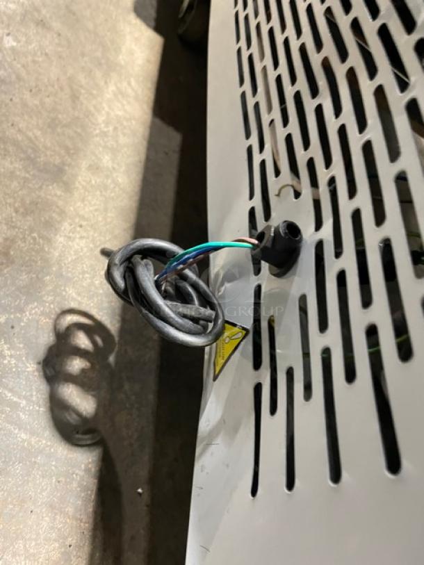 White multi-tier refrigerated bakery display, model ZSGLLQ18, with double glass sliding doors and visible wiring.