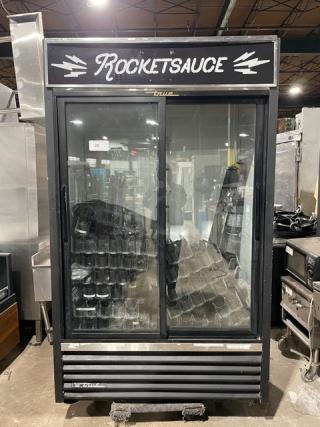 True GDM-41 black double glass sliding door reach-in merchandiser refrigerator with pusher glide bottle organizer, 115V, 1 phase.