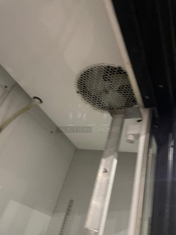 True GDM-41 Commercial Double Glass Door Refrigerator, black, with pusher glide bottle organizer, model GDM-41, SN: 570537.