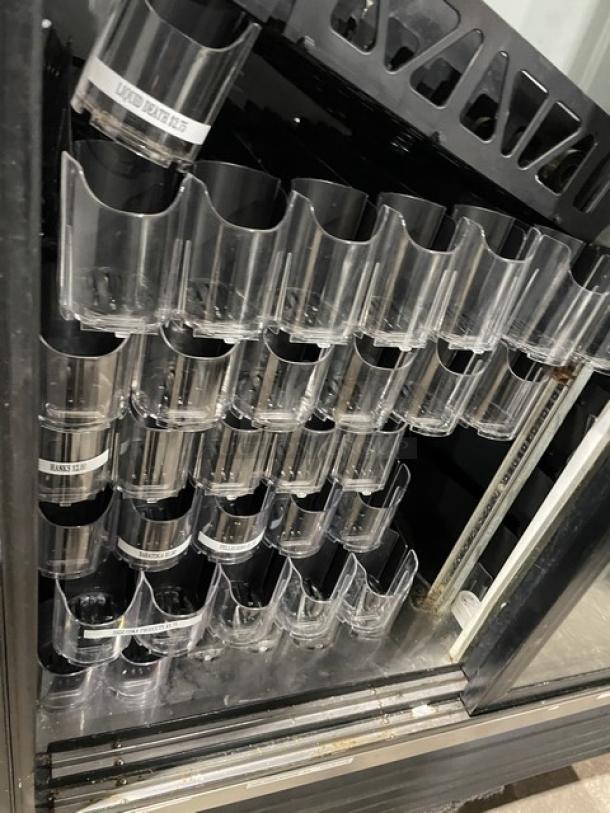 True GDM-41 commercial refrigerator with double glass sliding doors and pusher glide bottle organizer, model SN 570537.