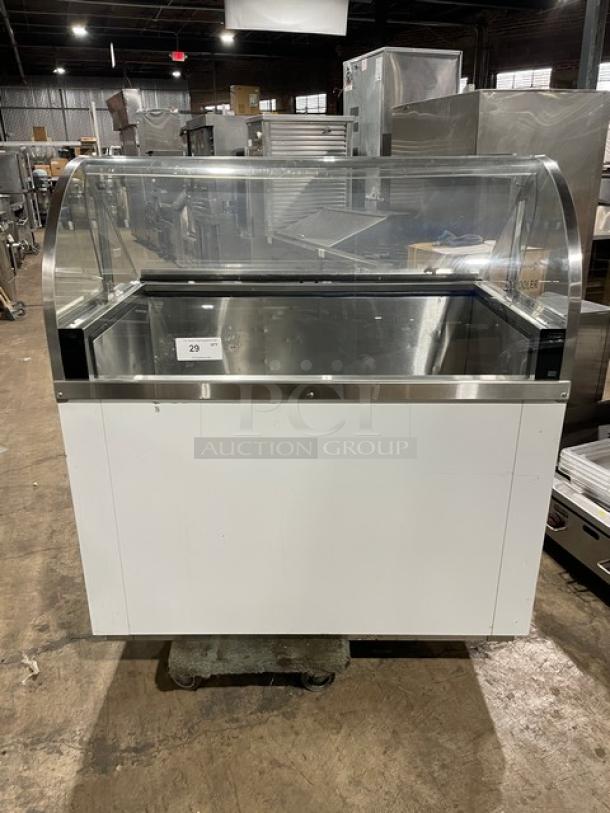 Commercial white curved glass horizontal ice cream/frozen yogurt dipping cabinet with rear lift-open access. SN: N1902303.
