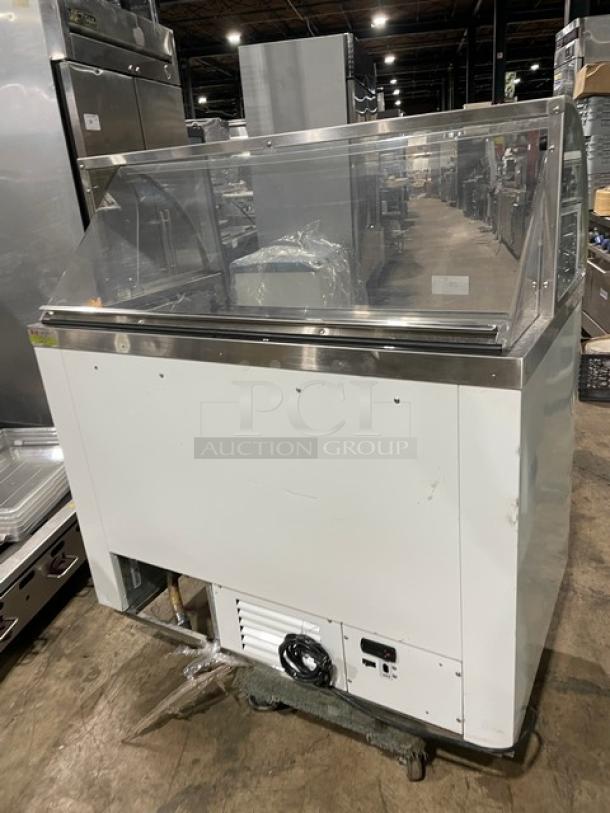 Commercial white curved glass ice cream dipping cabinet with rear lift-open access, SN: N1902303, used condition.