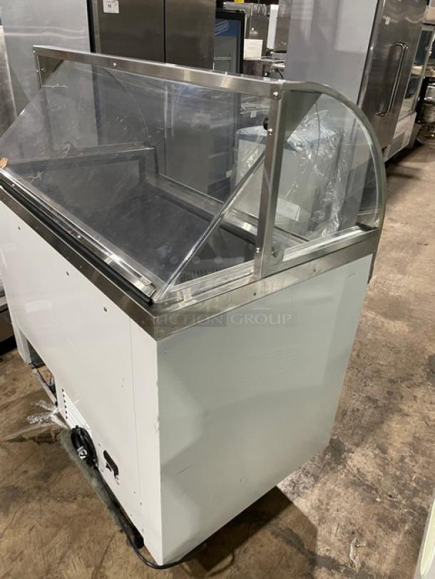 Commercial white curved glass ice cream dipping cabinet, rear lift-open access, SN: N1902303, in used condition.