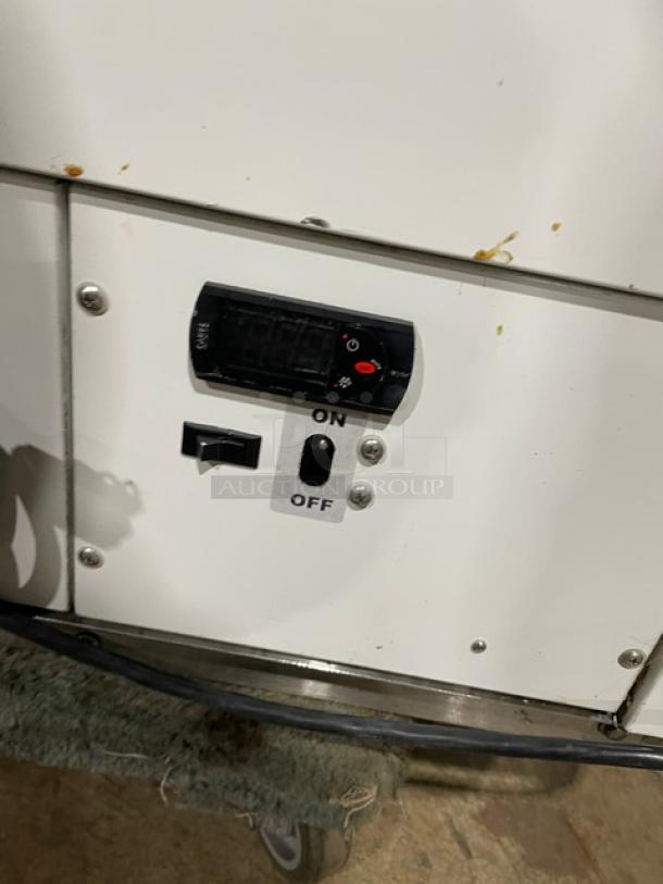 Commercial ice cream dipping cabinet with curved glass, white finish, rear lift-open access, SN: N1902303, on/off controls.