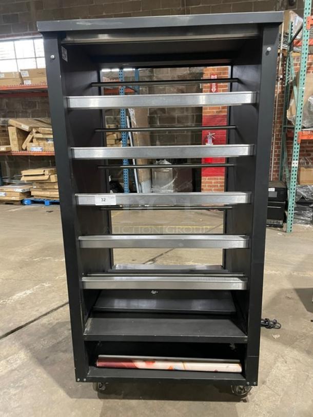 Vulcan Model 1013776 5-tier lighted bakery display case with stainless steel interior and enclosed storage, on casters.