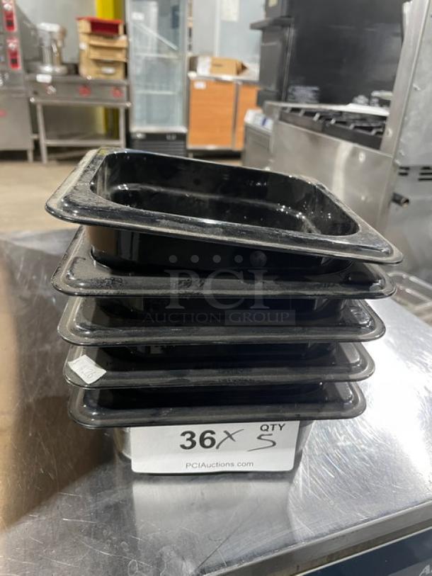 NEW Cambro black 1/6-size 2.5" deep food pans, set of five. Stack of pans in a commercial kitchen setting; labeled as quantity 36 on auction site.
