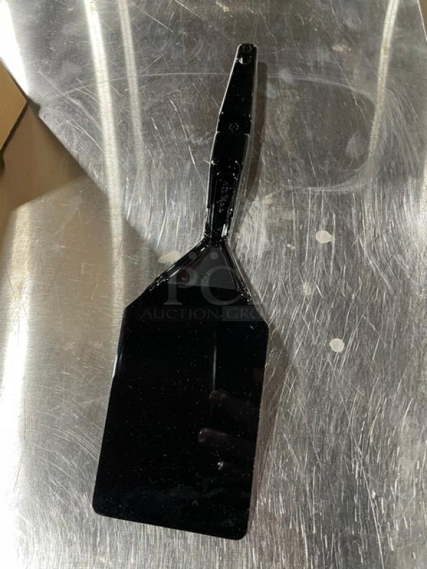 Cambro Camtensil 14" Black High Heat Solid Turner/Spatula in new condition on a metal surface.