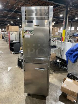 Traulsen stainless steel half door refrigerator, model AHT132DUTHHS, with wired racks, 115V, on casters, in used condition.