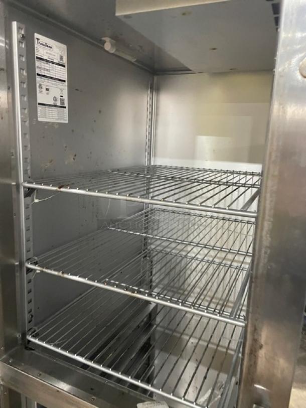Traulsen commercial stainless steel half door refrigerator, model AHT132DUTHHS, with wired racks, on casters, good condition.