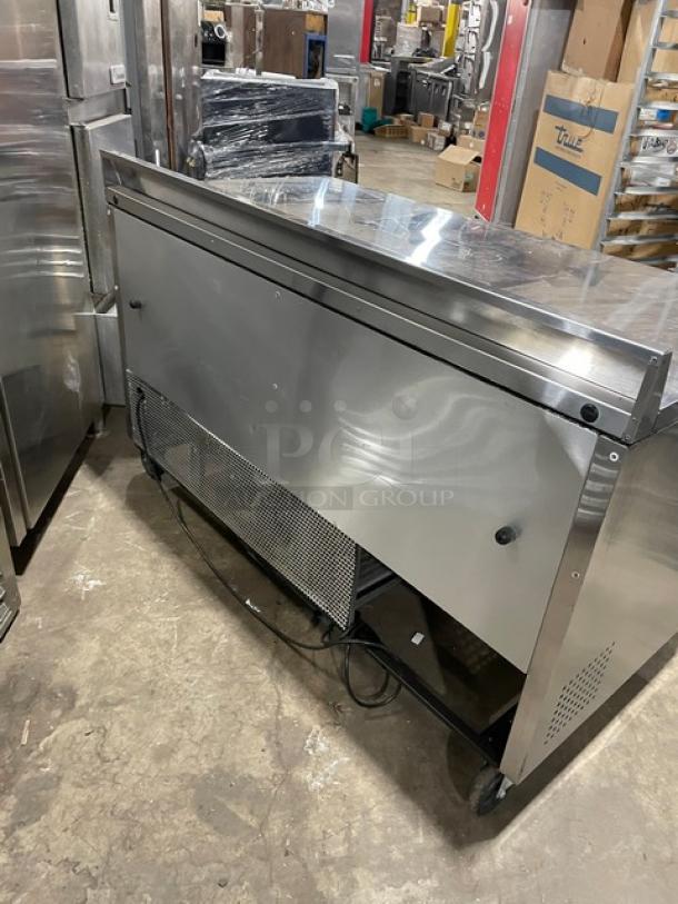 True TWT-60 stainless steel 2-door worktop refrigerator with backsplash, poly coated rack, on casters, Energy Star certified.