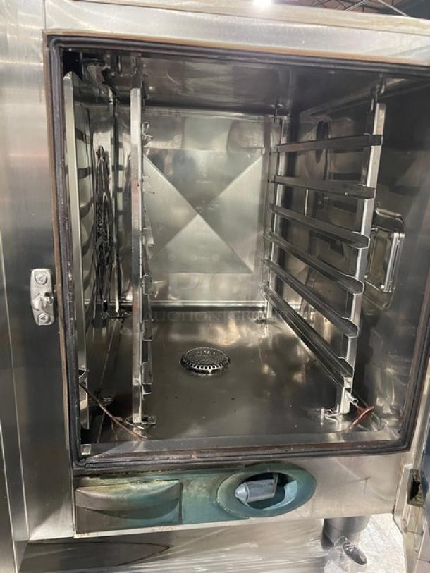 Rational SelfCooking Center Series combi oven, commercial grade, stainless steel, built-in pan slide, on legs, interior view.
