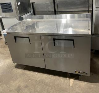 True TWT-60 stainless steel 2-door worktop refrigerator with backsplash, poly coated rack, on casters, Energy Star certified.