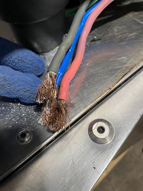 Frayed electrical wires on stainless steel surface of Alto-Shaam 714ESISK combi/smoker oven.