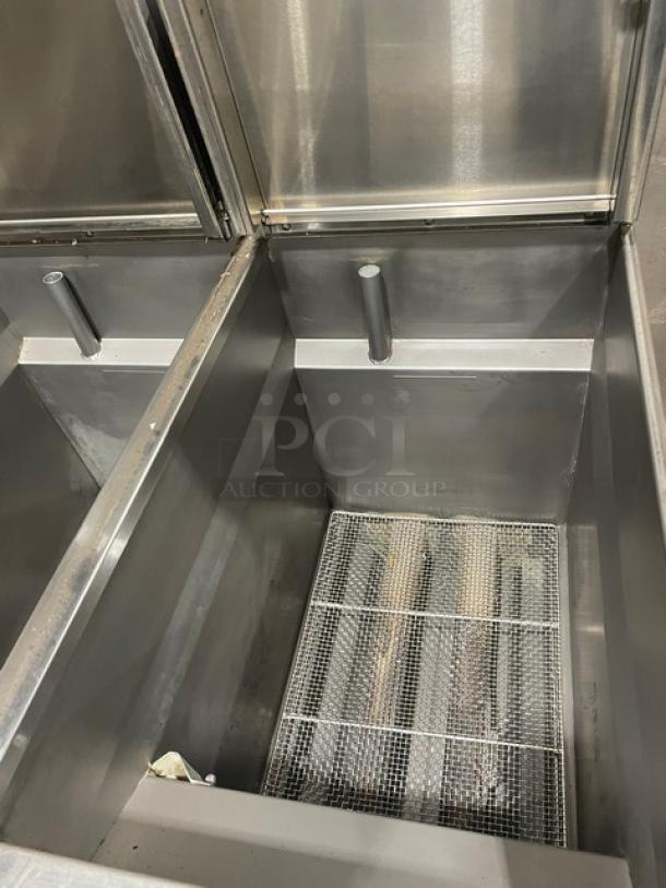 Pitco SRTG commercial stainless steel 3-bay pasta cooker, 17.5 gal capacity, natural gas, with backsplash, on casters.